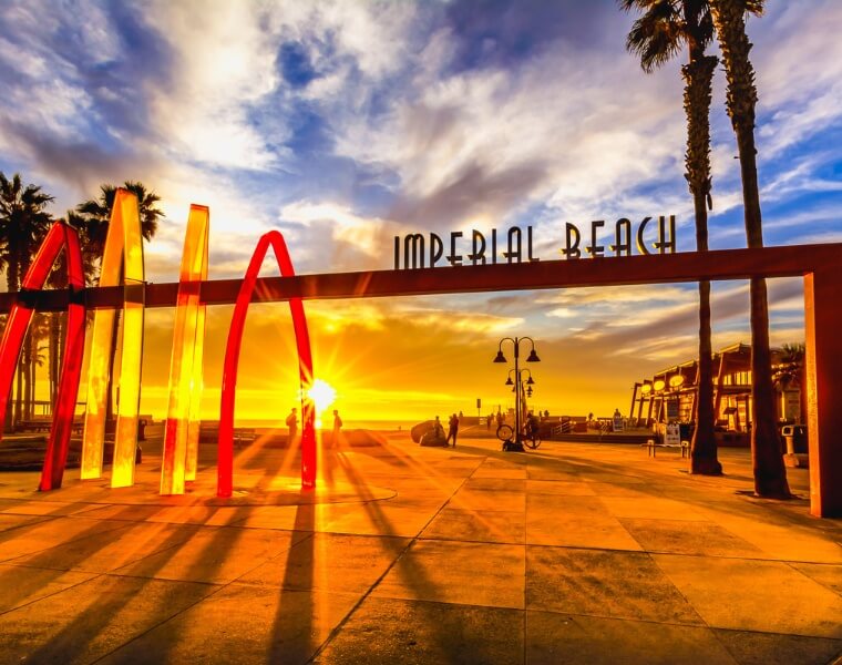 Sunset view of the Imperial Beach sign with vibrant colors, representing the charm of the coastal city where ADU construction is thriving.