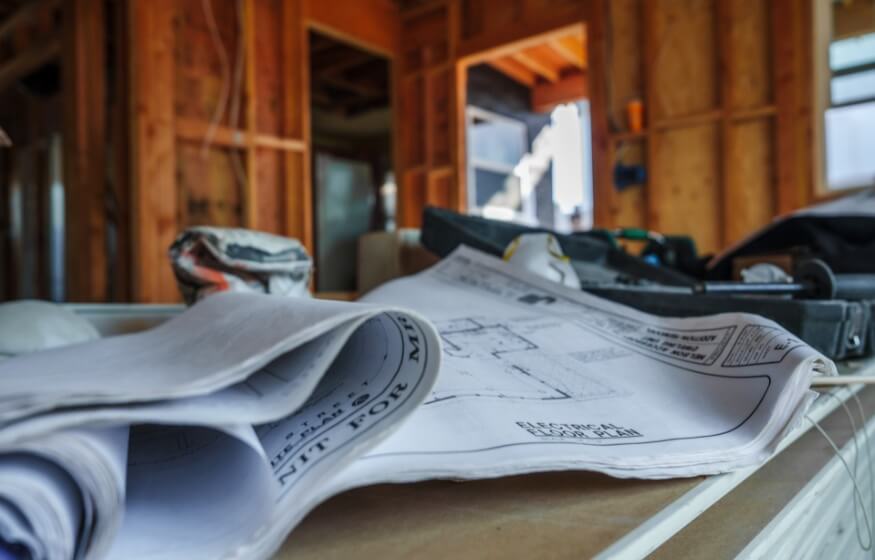 Close-up of construction blueprints inside an ADU project, representing expert answers to ADU FAQs in National City.