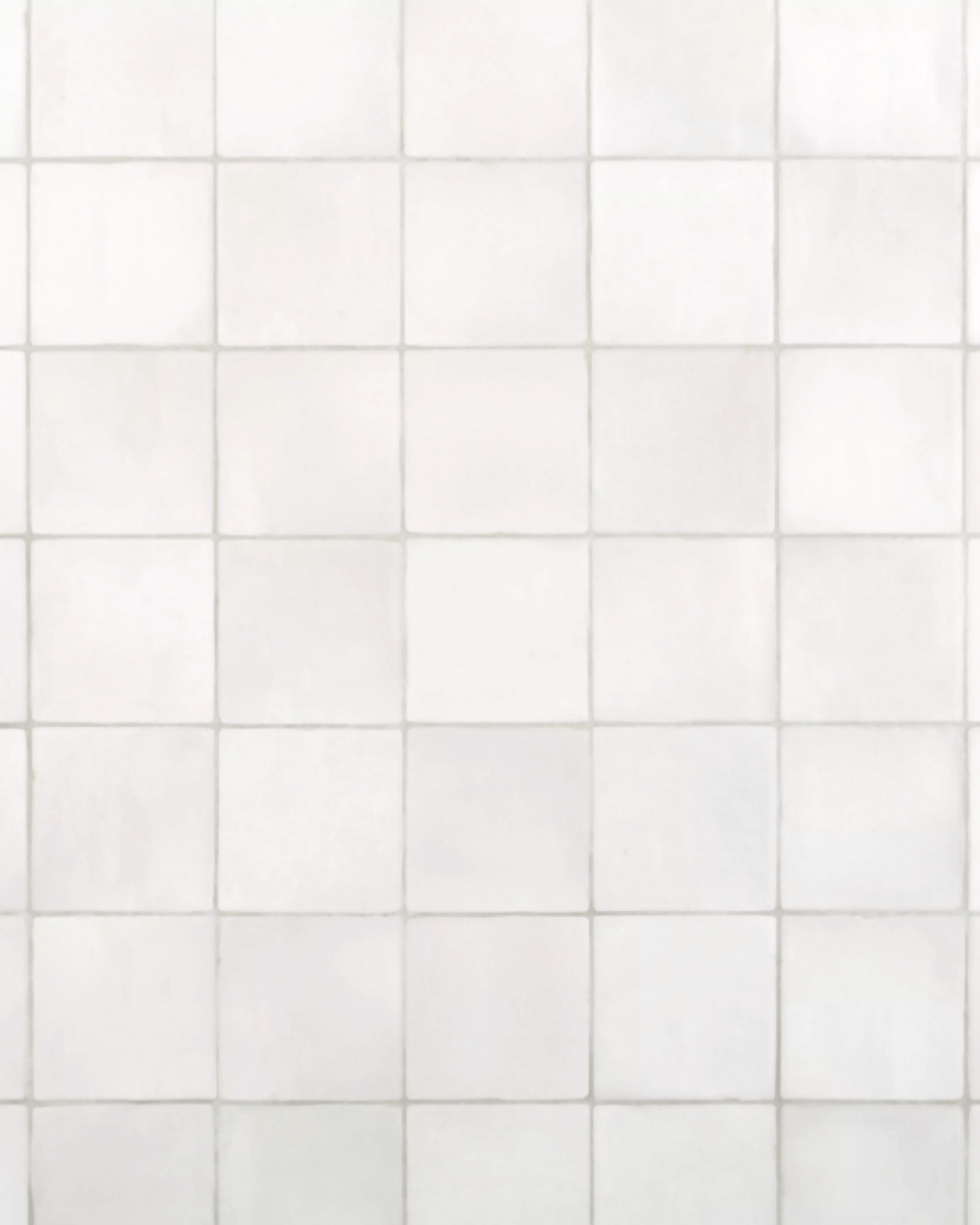 Elegant Zellige Perla polished ceramic tile backsplash, featuring subtle variations of soft white tones with a handcrafted, glossy finish.