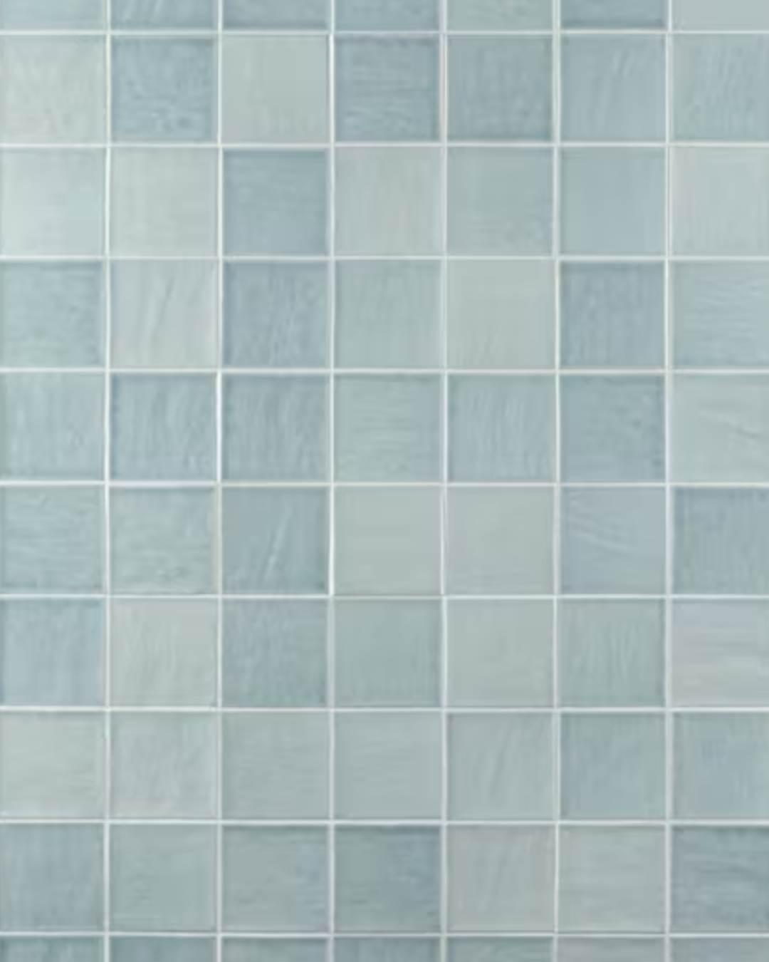 Glossy, square zellige-style ceramic tiles in a soft sky-blue shade.