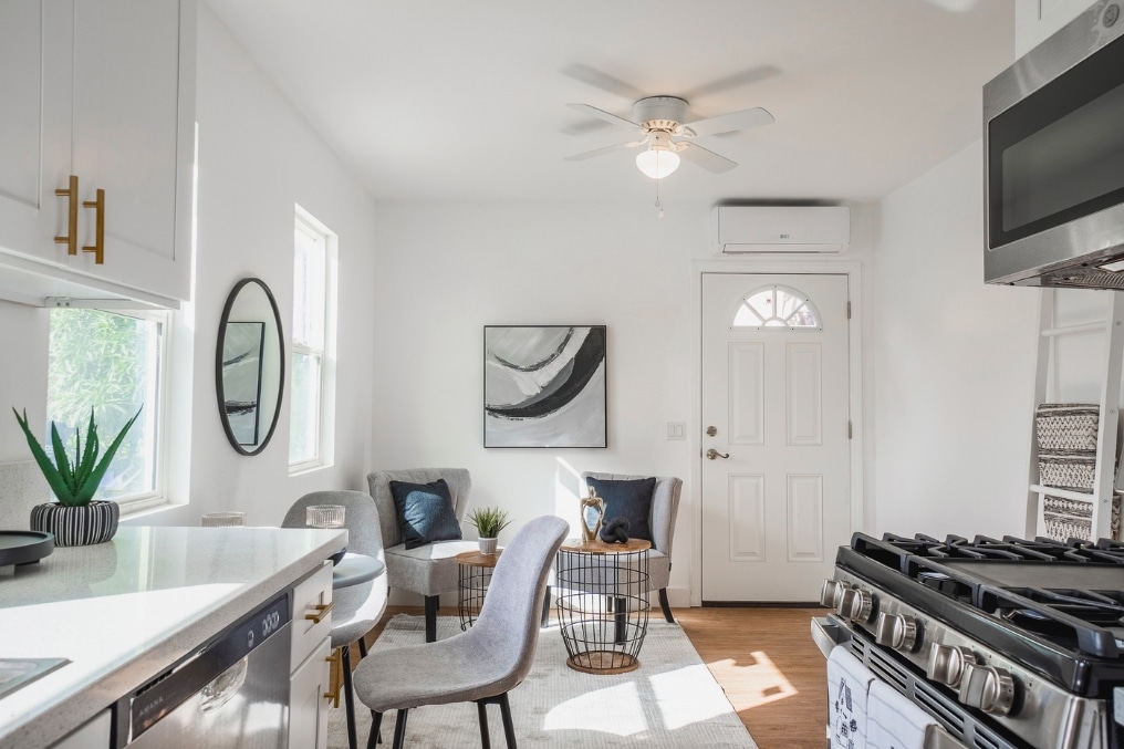 a kitchen with white cabinets and a sink