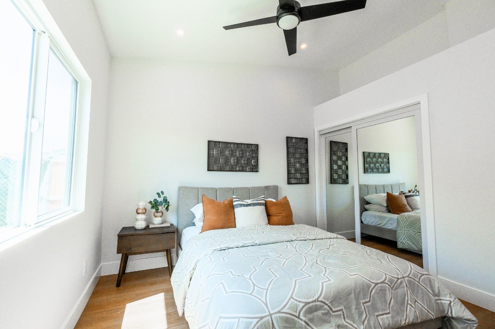 Bright bedroom featuring modern decor and large mirrored closet in Pacific Beach ADU