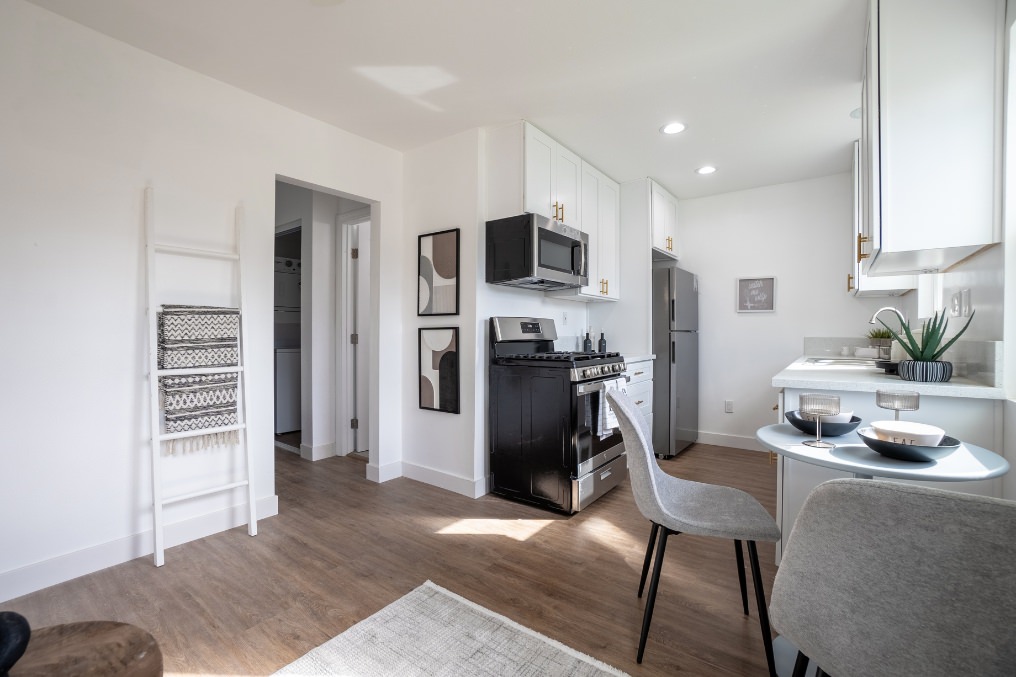 Open-concept kitchen and dining area with modern decor in La Mesa garage conversion ADU.