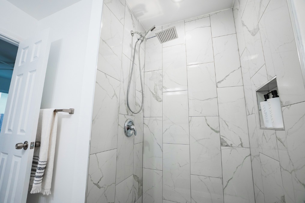 Modern walk-in shower with elegant tile finish in La Mesa garage conversion ADU.