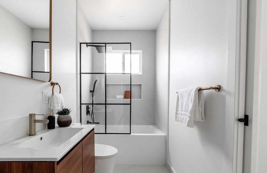Double vanity bathroom with wood cabinetry and matte black fixtures in Maple adu floor plans 800 sq ft layout