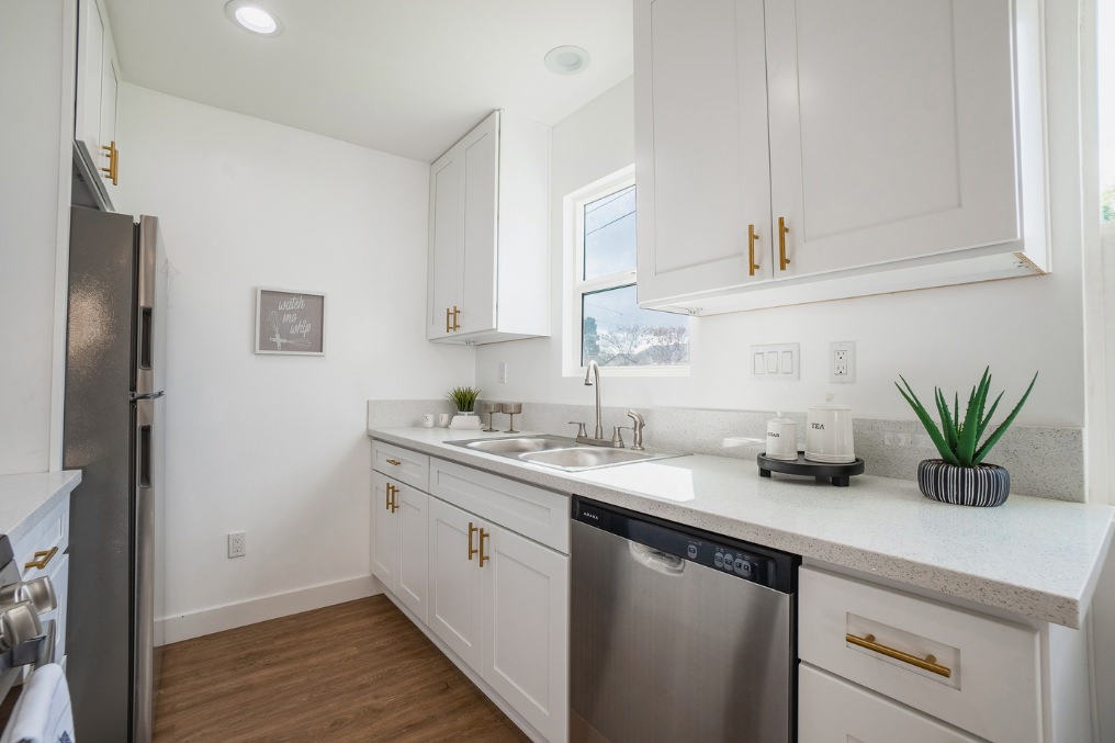 Bright and modern kitchen in La Mesa ADU with white cabinetry and stainless steel appliances.