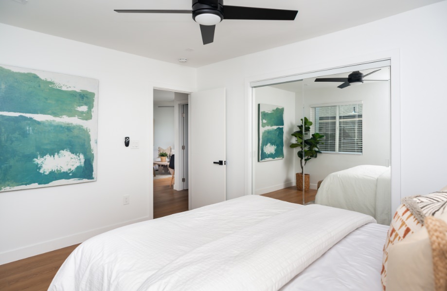 Modern bedroom with mirrored closet doors from the Pine ADU floor plan recommendation, showcasing smart layout choices in 900 sq ft ADU plans.