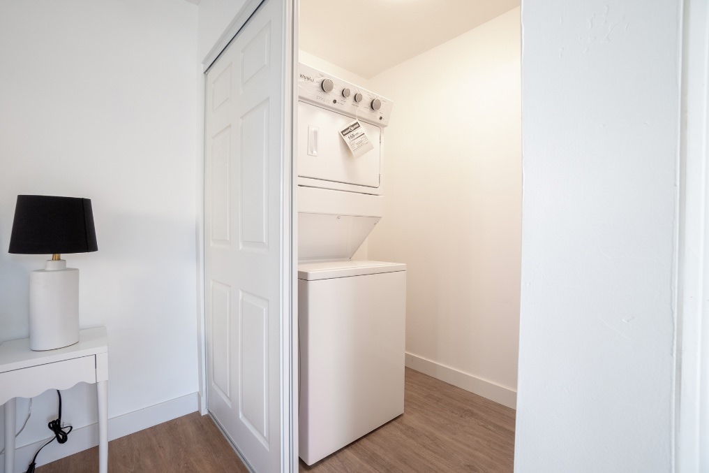 Efficient stacked washer and dryer neatly tucked into closet in La Mesa ADU.