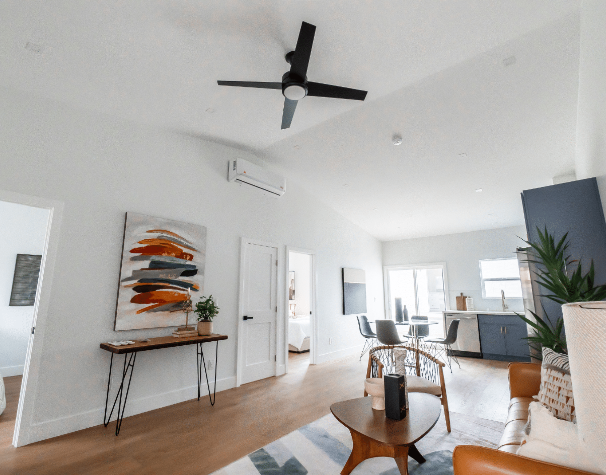 Interior of an ADU with modern design elements, including a vaulted ceiling, minimalist furniture, and an open-concept layout. The space showcases natural lighting, contemporary decor, and compliance with ab1033 standards for accessory dwelling units.