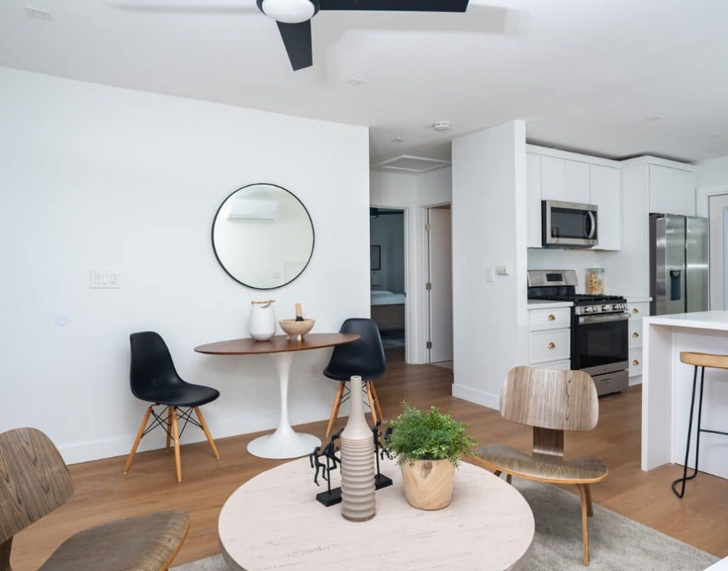 An open floor plan in a contemporary ADU, seamlessly connecting the kitchen, dining, and living areas for a cohesive design.