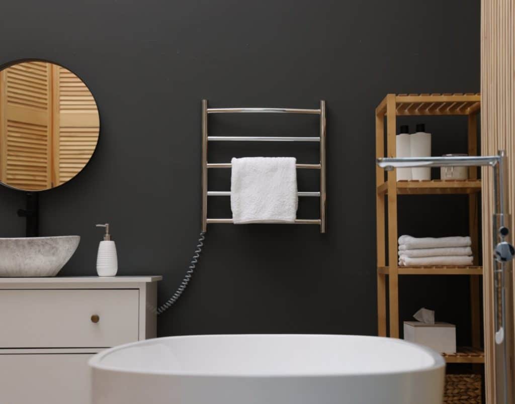 Modern bathroom with a sleek towel warmer and minimalistic decor.