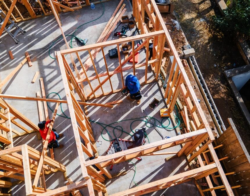 Conclusion – completed ADU construction with framed walls and contractors working.