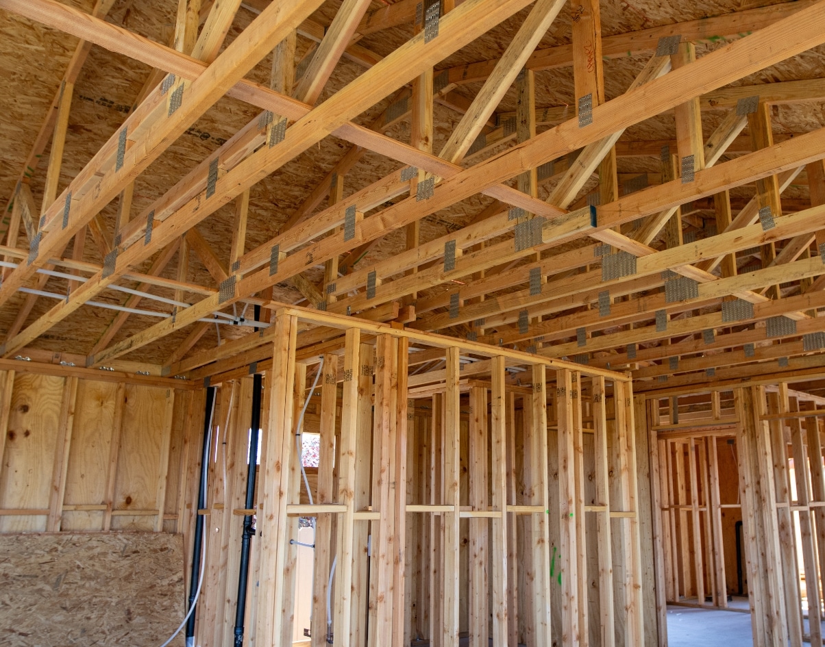 Close-up of wood framing in progress for the interior of a junior ADU in a San Diego residence, showing structural work before drywall installation.