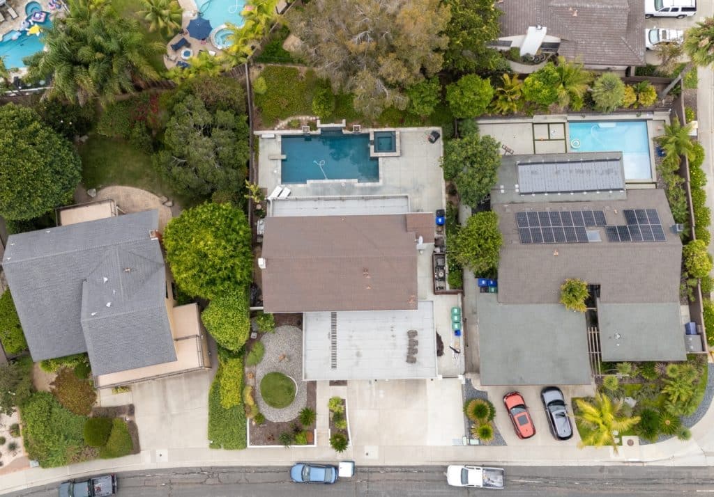 Aerial view of an ADU under construction beside a primary residence, showcasing the scale and layout possibilities within California's size limits.