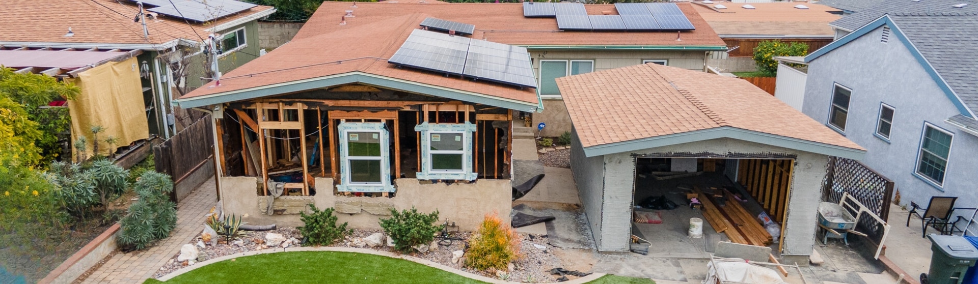 A partially constructed ADU with solar panels, showcasing sustainable upgrades and energy-efficient solutions in the early stages of development.