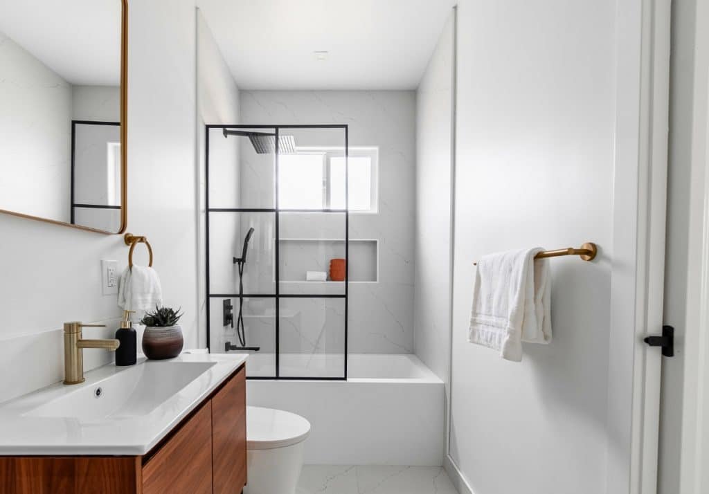 Bold tilework adding a pop of color to a neutral bathroom in an ADU