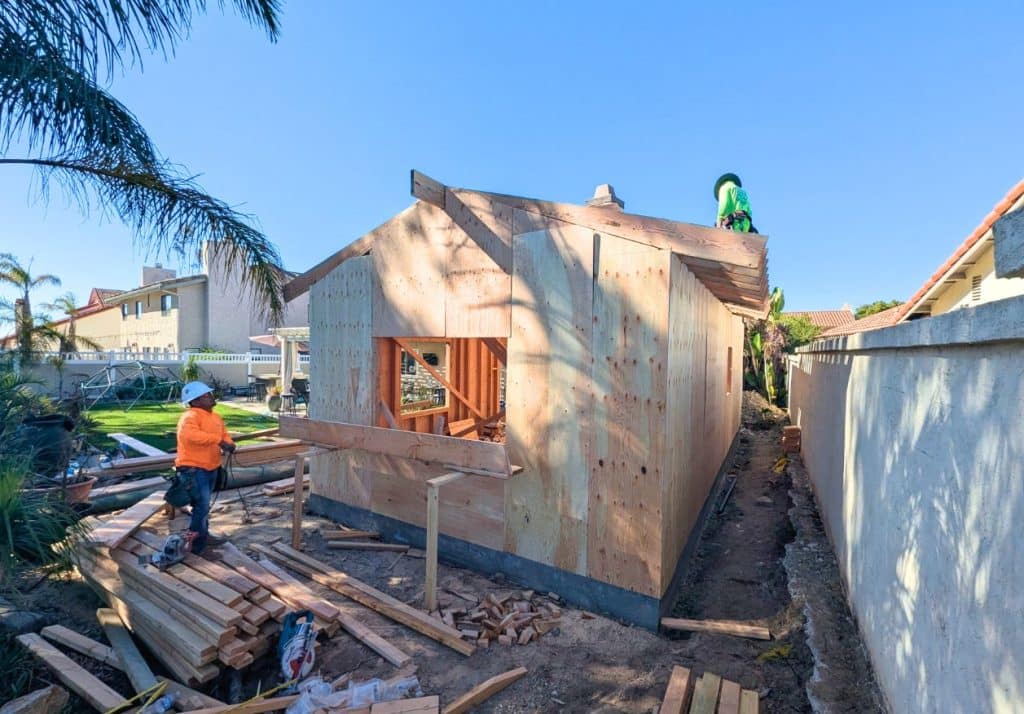 Backyard ADU construction in progress, showcasing framing and site preparation.