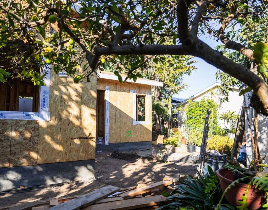 An ADU under construction surrounded by lush greenery emphasizing a strong connection with nature.