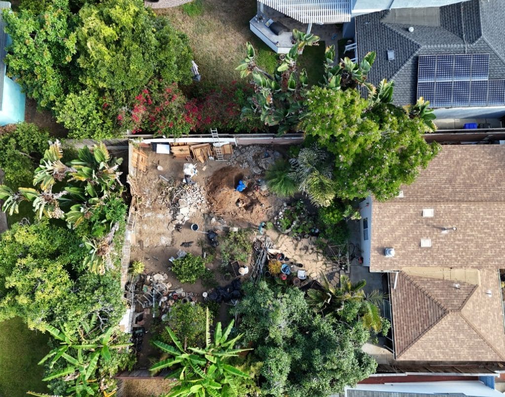 An aerial view of a property undergoing site assessment and soil testing for ADU construction.