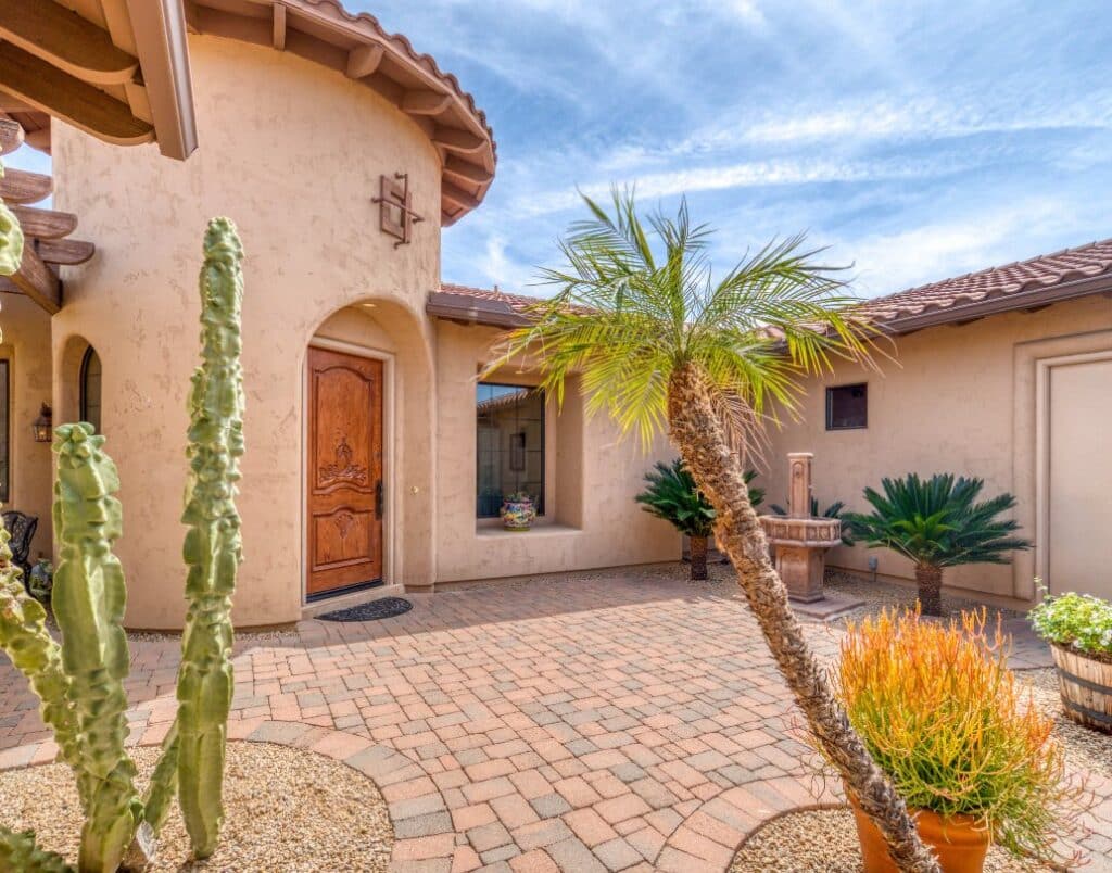 A charming courtyard with a tile roof and stucco walls in a Spanish-style ADU.