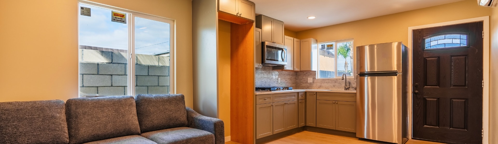 Interior view of a completed ADU with a modern kitchen and living space in San Diego.