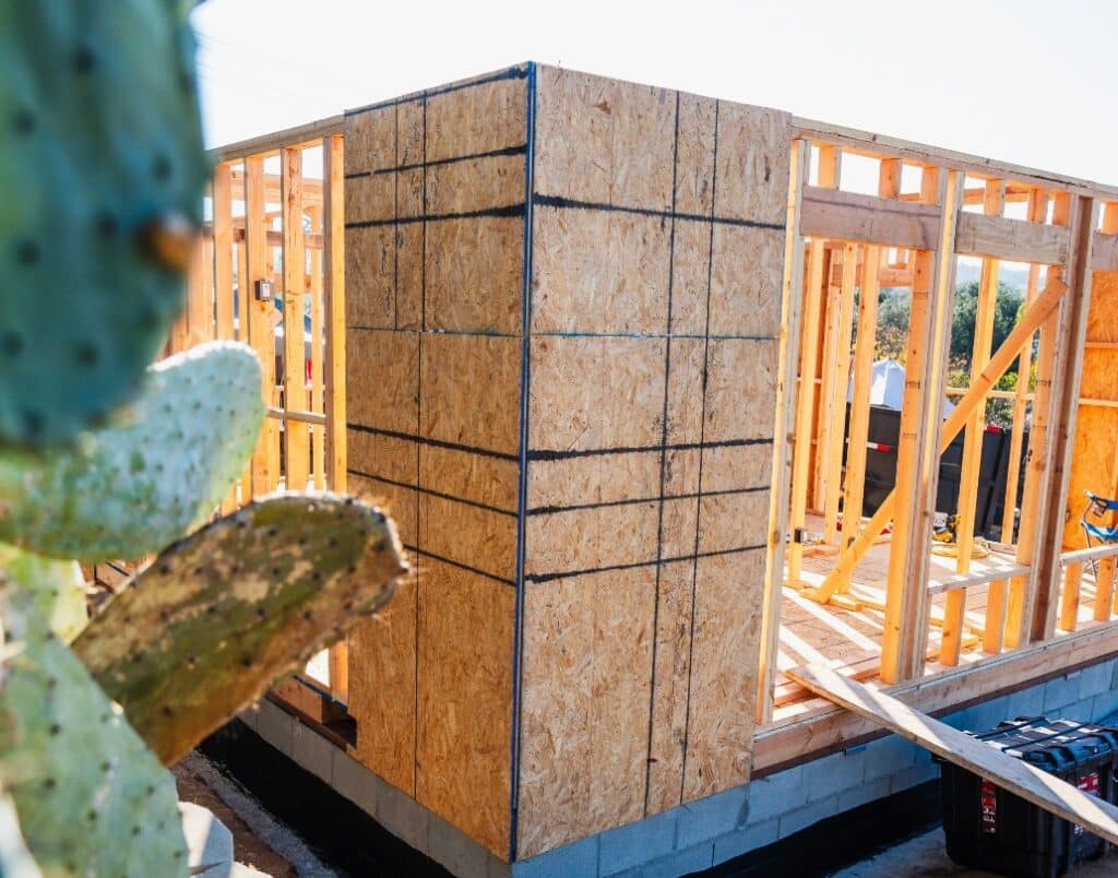 Construction progress of an Accessory Dwelling Unit (ADU) foundation and framing.