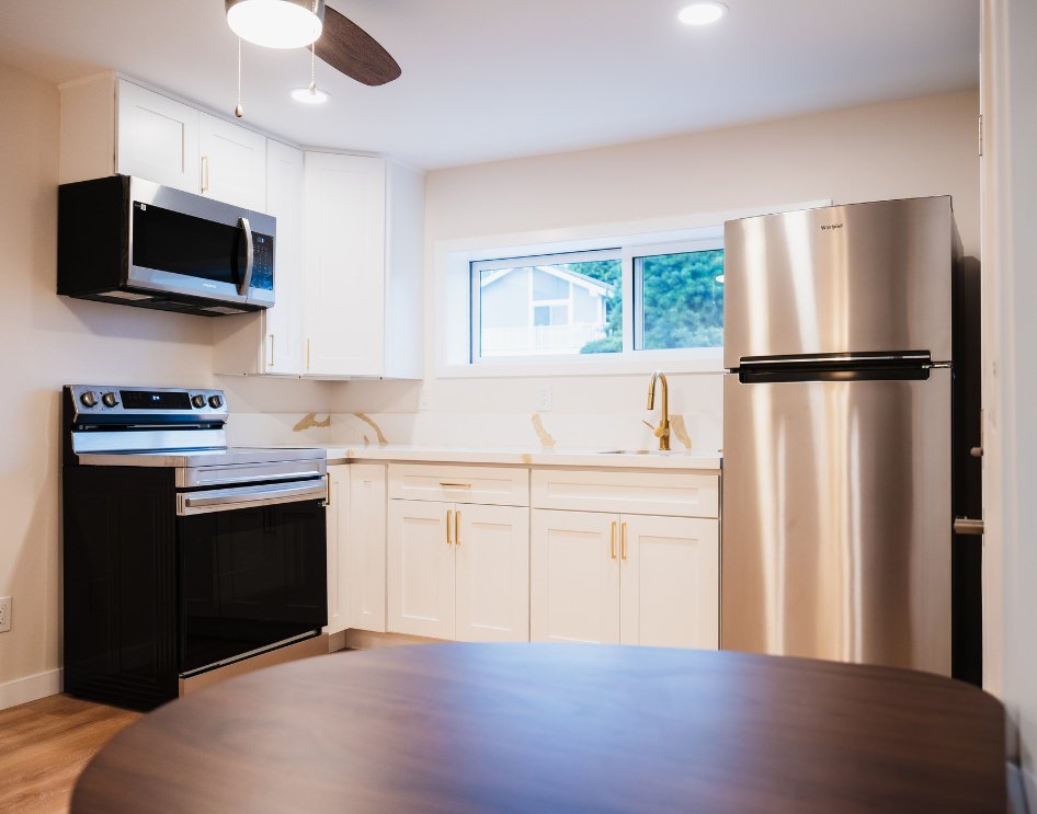 Modern casita kitchen featuring sleek appliances, custom cabinetry, and a compact design.