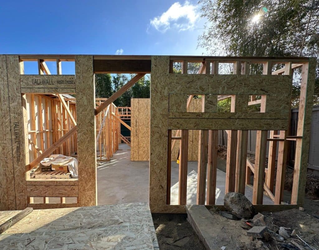 Bird’s-eye view of an ADU under construction, highlighting California’s simplified building rules like reduced setbacks, streamlined permitting, and pre-approved plans.