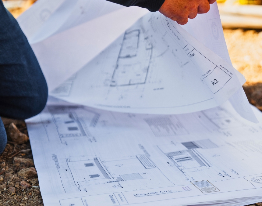 Detailed view of ADU project documentation spread on a worktable