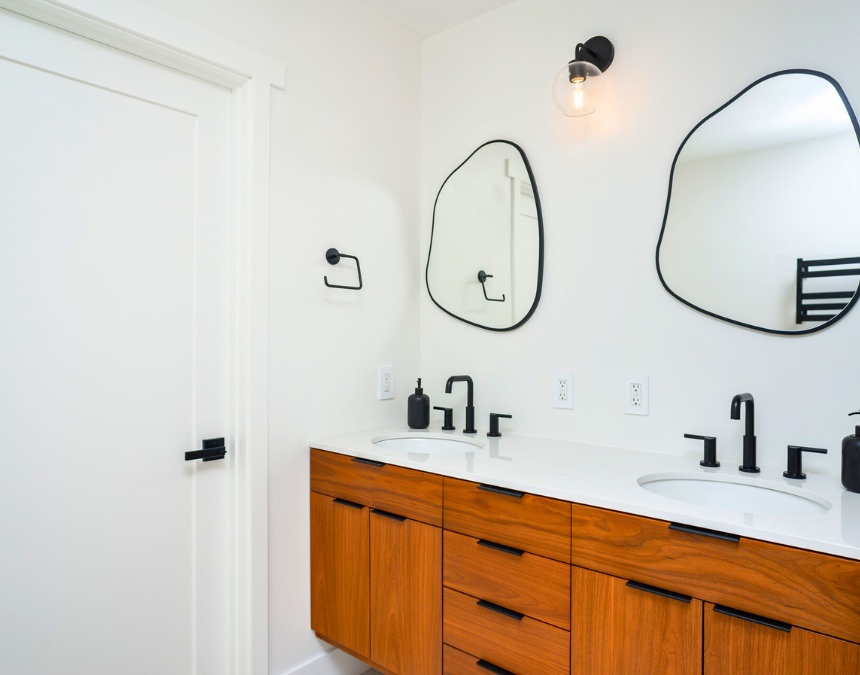 Modern ADU bathroom with installed fixtures, showcasing final plumbing costs.