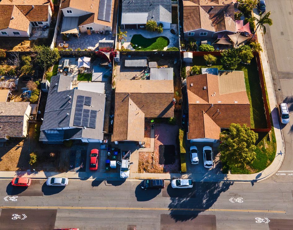 Aerial view of suburban homes with neatly maintained lawns, showcasing typical HOA-governed neighborhoods in California.