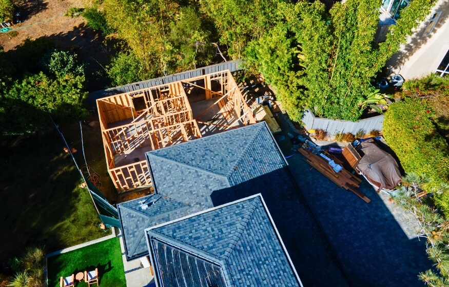 Aerial view of 2 bedroom 2 bath ADU under construction behind primary home – 1000 SQ FT 2 Bedroom 2 Bath ADU FAQs 1 – representing real-world execution of 2 bedroom 2 bath ADU plans.