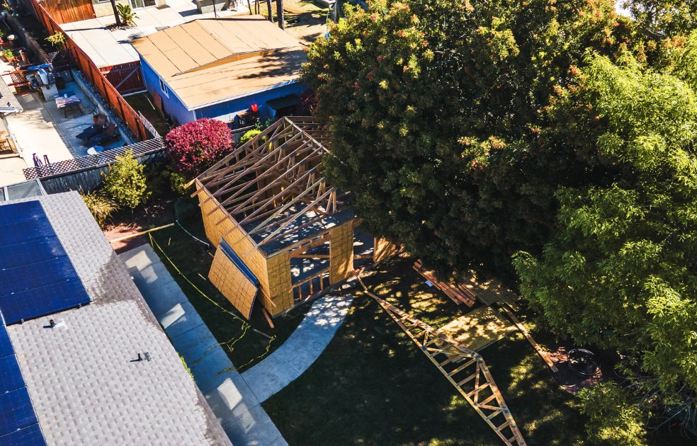 Aerial view of adu floor plans 880 sq ft under construction showing roof framing and lot placement