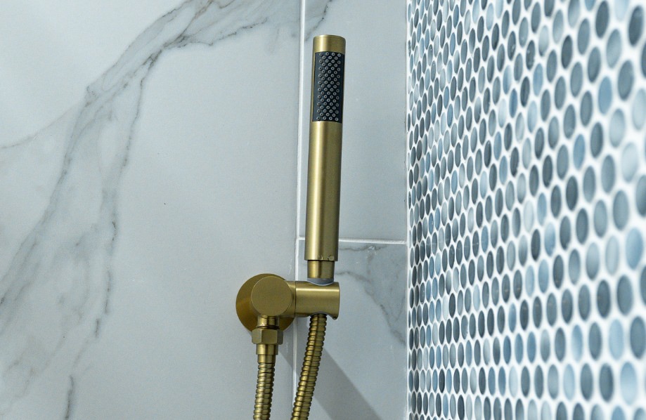 Modern gold shower fixture and mosaic tile detail in bathroom of adu floor plans 880 sq ft – Cherry layout