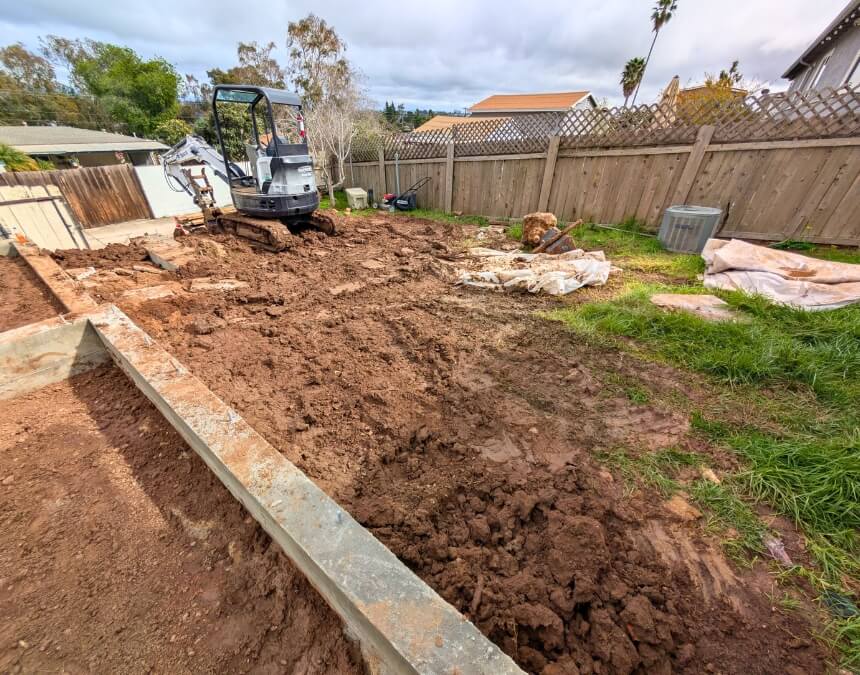 Excavator working on residential lot – How Much Does a Soil Report Cost