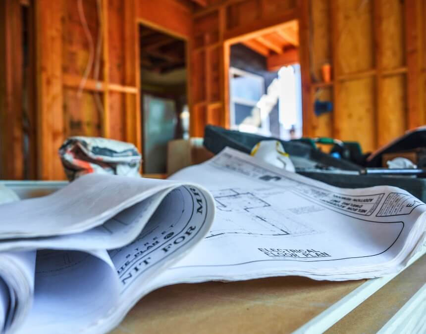 Rolled architectural plans showcasing how to maximize space while meeting ADU setback requirements