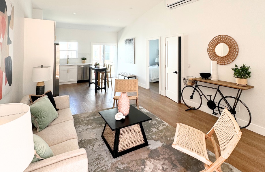 Interior design recommendation view of the Tamarind 950 sq ft ADU featuring a cozy living room with warm natural light and open access to kitchen and bedroom areas.