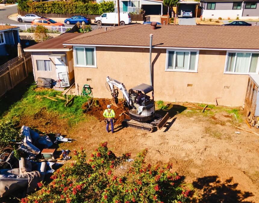 Excavator digging in residential backyard what is an ADU septic system