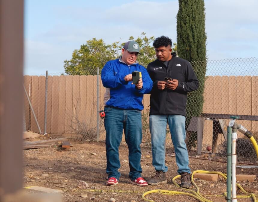 Two contractors reviewing what is the timeline for adding a septic system to your ADU