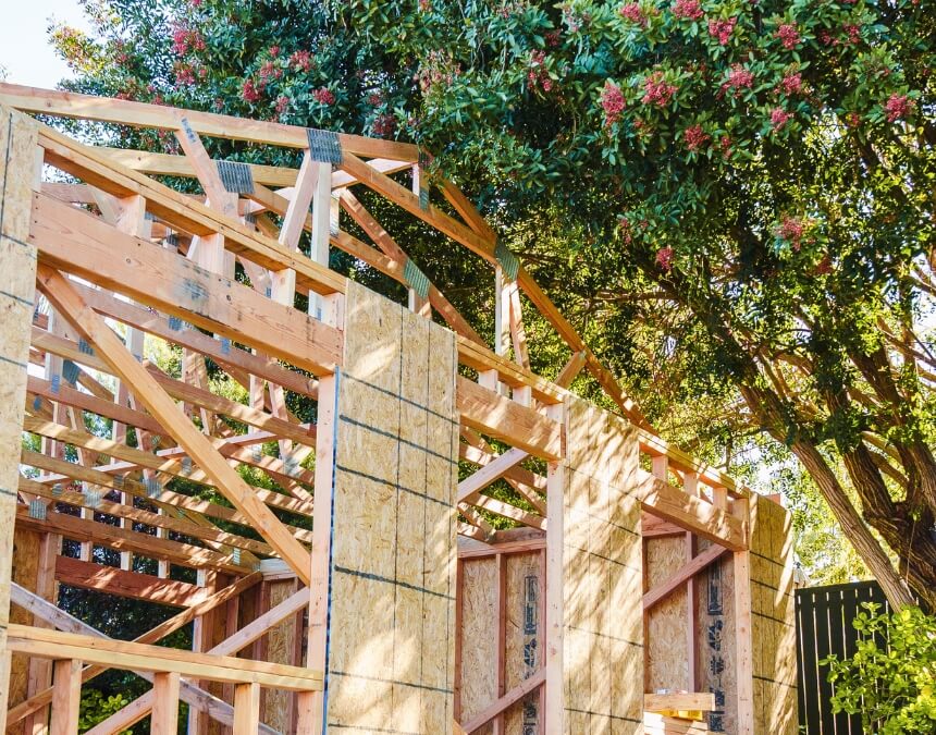 Contractor reviewing ADU blueprints defining home construction warranty