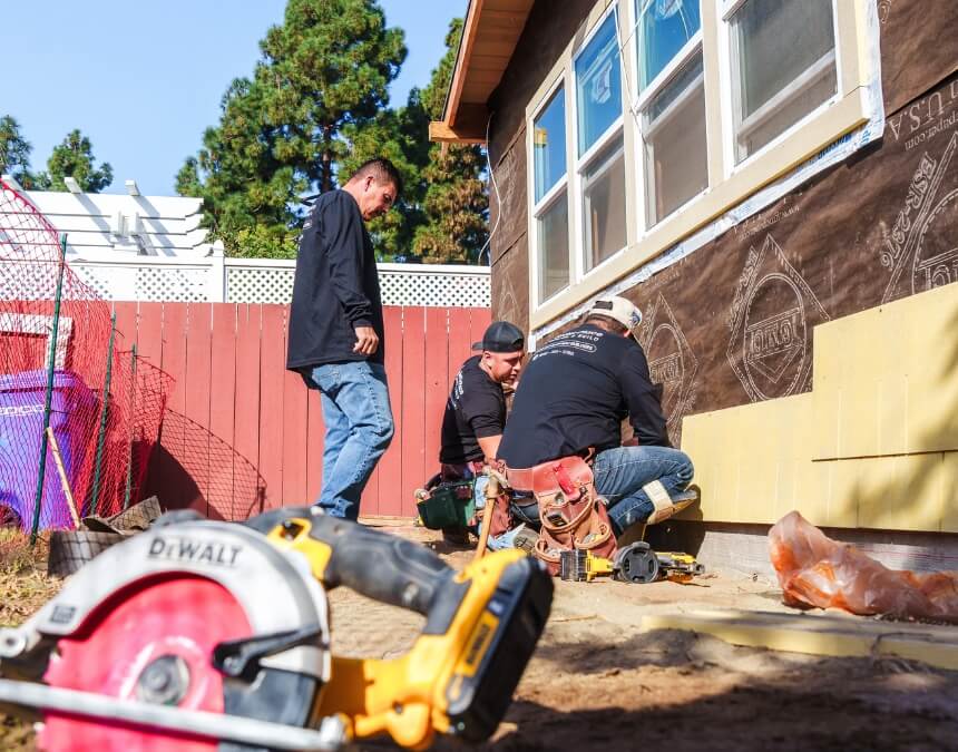 Crew installing siding during ADU construction with warranty protection