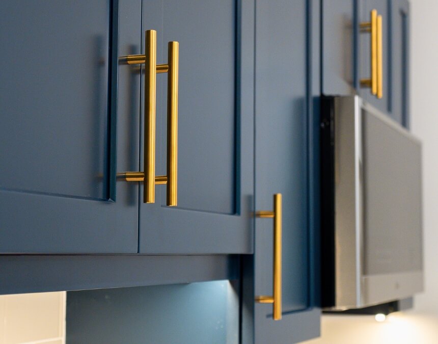 Key Takeaways image of a compact ADU kitchen with white cabinetry and natural light