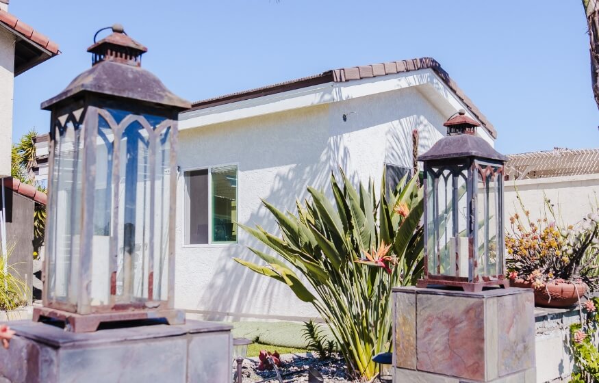 White stucco ADU exterior in Mission Valley surrounded by garden and patio lighting