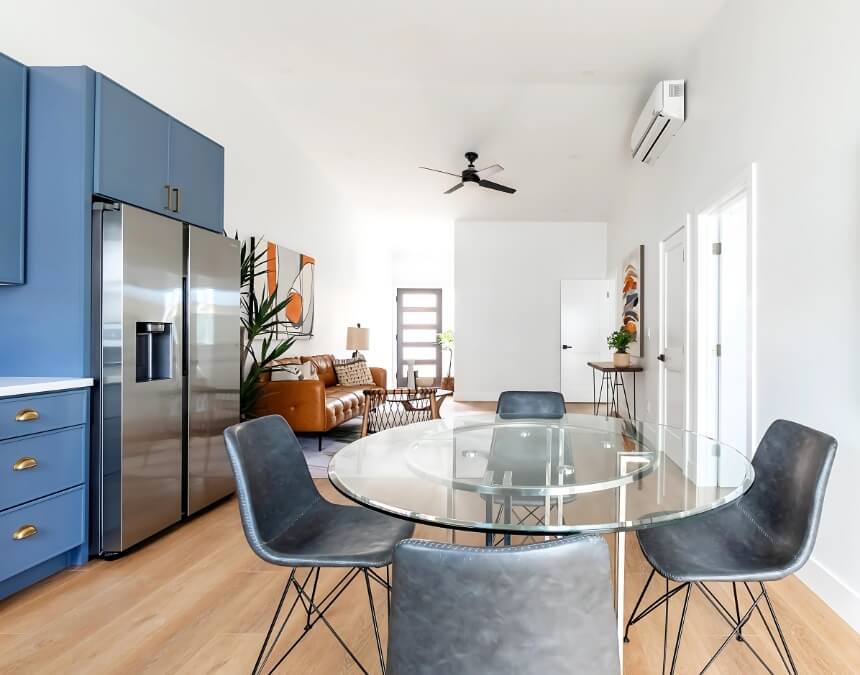 Multi-Functional Features for Efficiency in a U-shaped white kitchen with gold accents