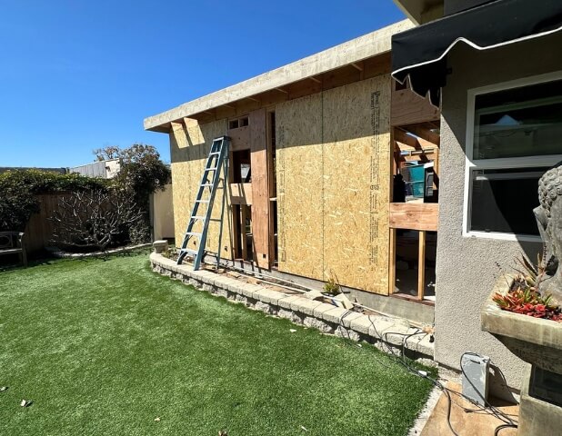 View of a completed ADU with matching stucco finish and roofline, illustrating required architectural compatibility – Architectural Fit