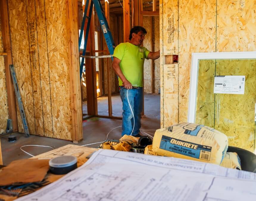 How Better Place Design & Build Can Help – contractor working on ADU construction with plans visible.