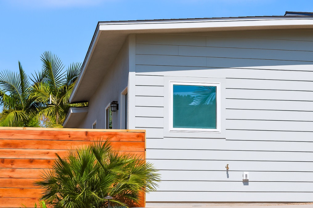 Side exterior close-up of attached ADU highlighting contemporary siding and wood fence detail.