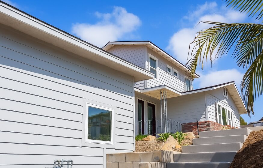 White multi-unit home exterior representing FAQs in “Common Questions for 800 sqft ADUs,” highlighting typical ADU placement and structure.