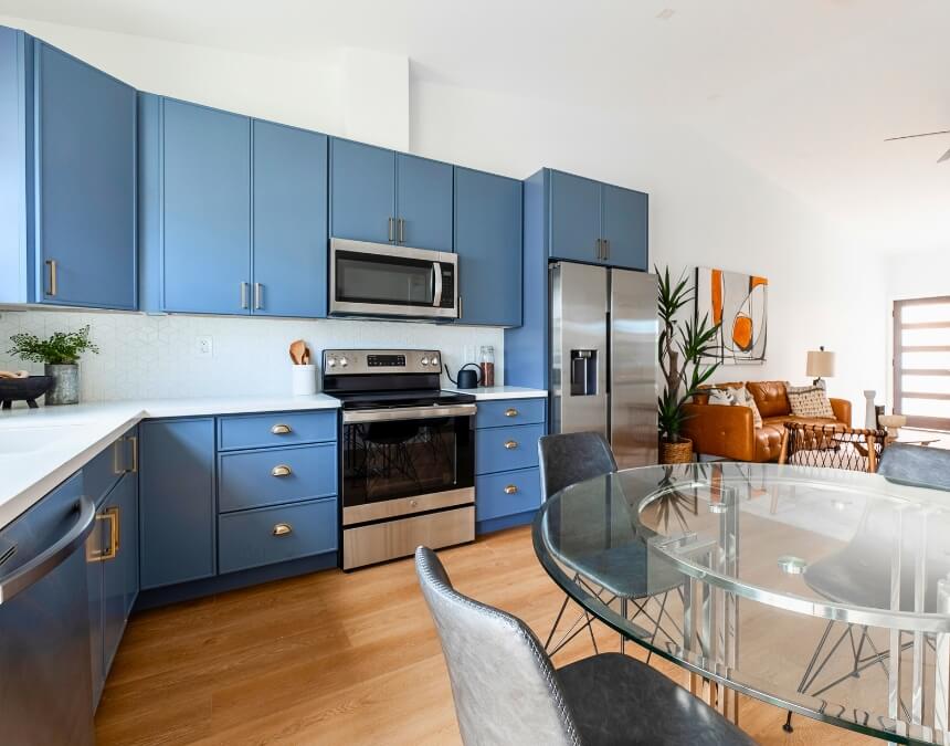 Bright, modern ADU kitchen with stainless appliances and a cozy living area.