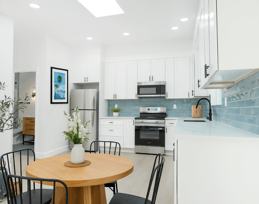 Bright, modern ADU kitchen featuring energy-efficient LED lighting, stainless steel appliances, and programmable thermostat integration.